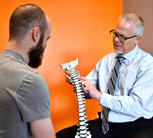 Chiropractor Colorado Springs CO Dr Todd Adams Educating Patient